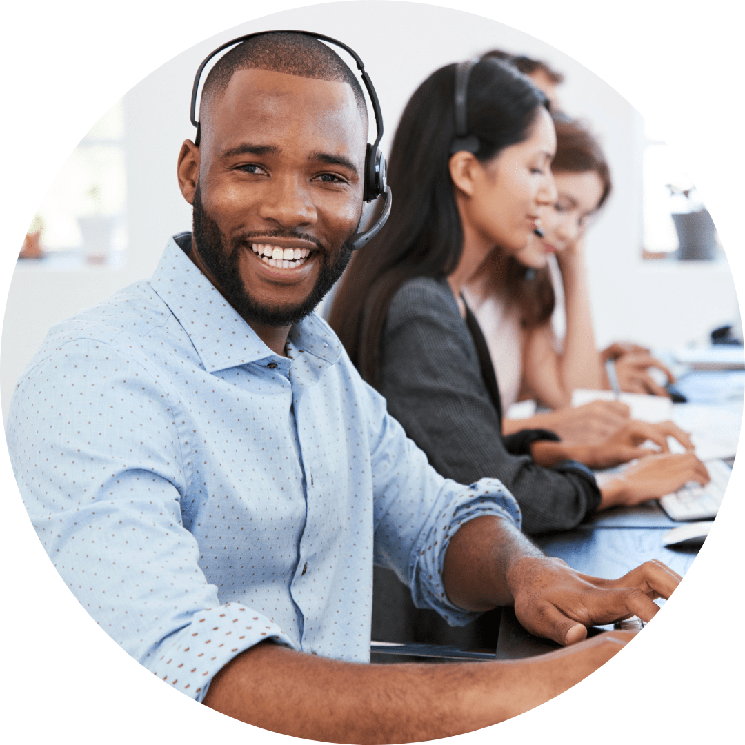 IT support technician is smiling while working at a help desk