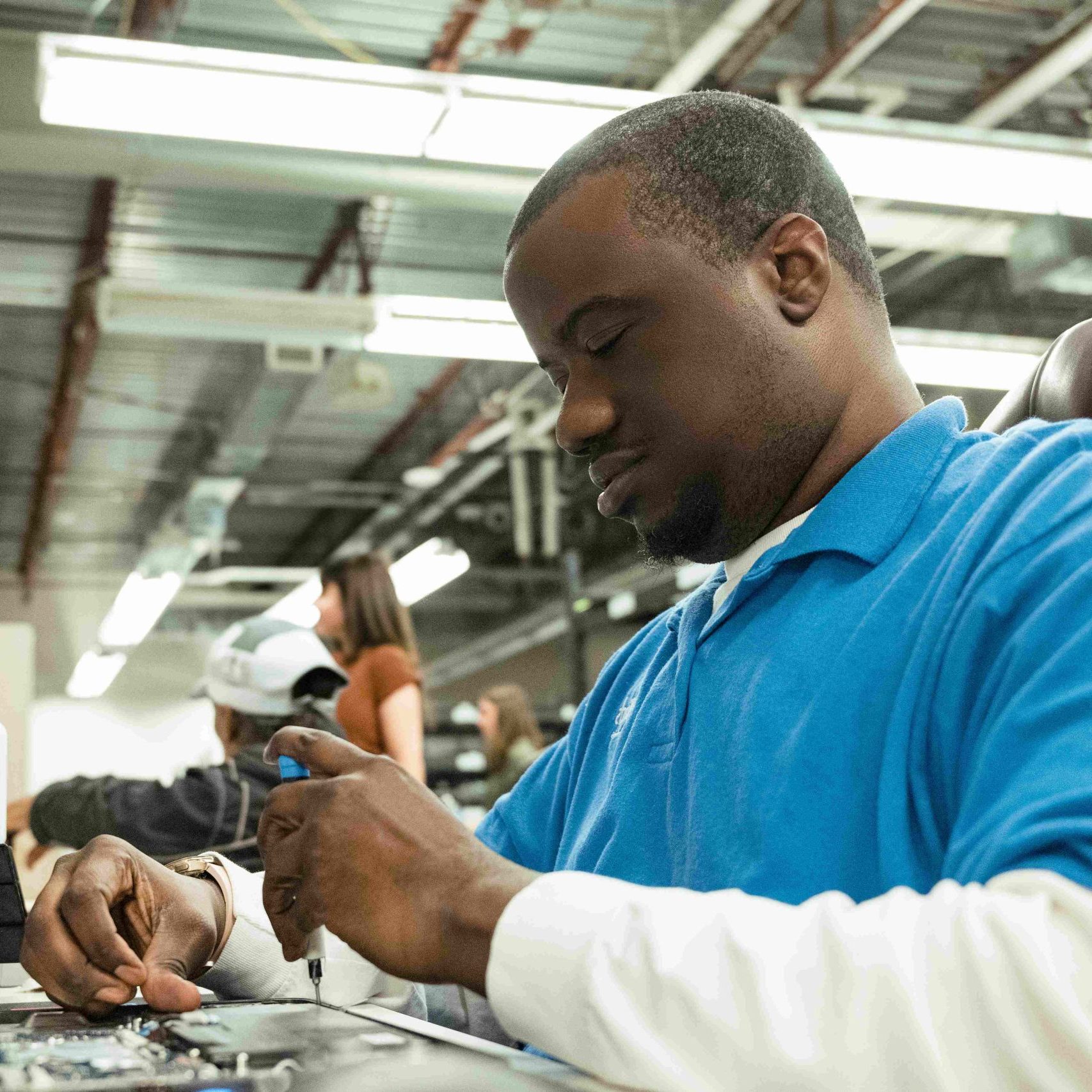 Clear Winds employee repairing laptop