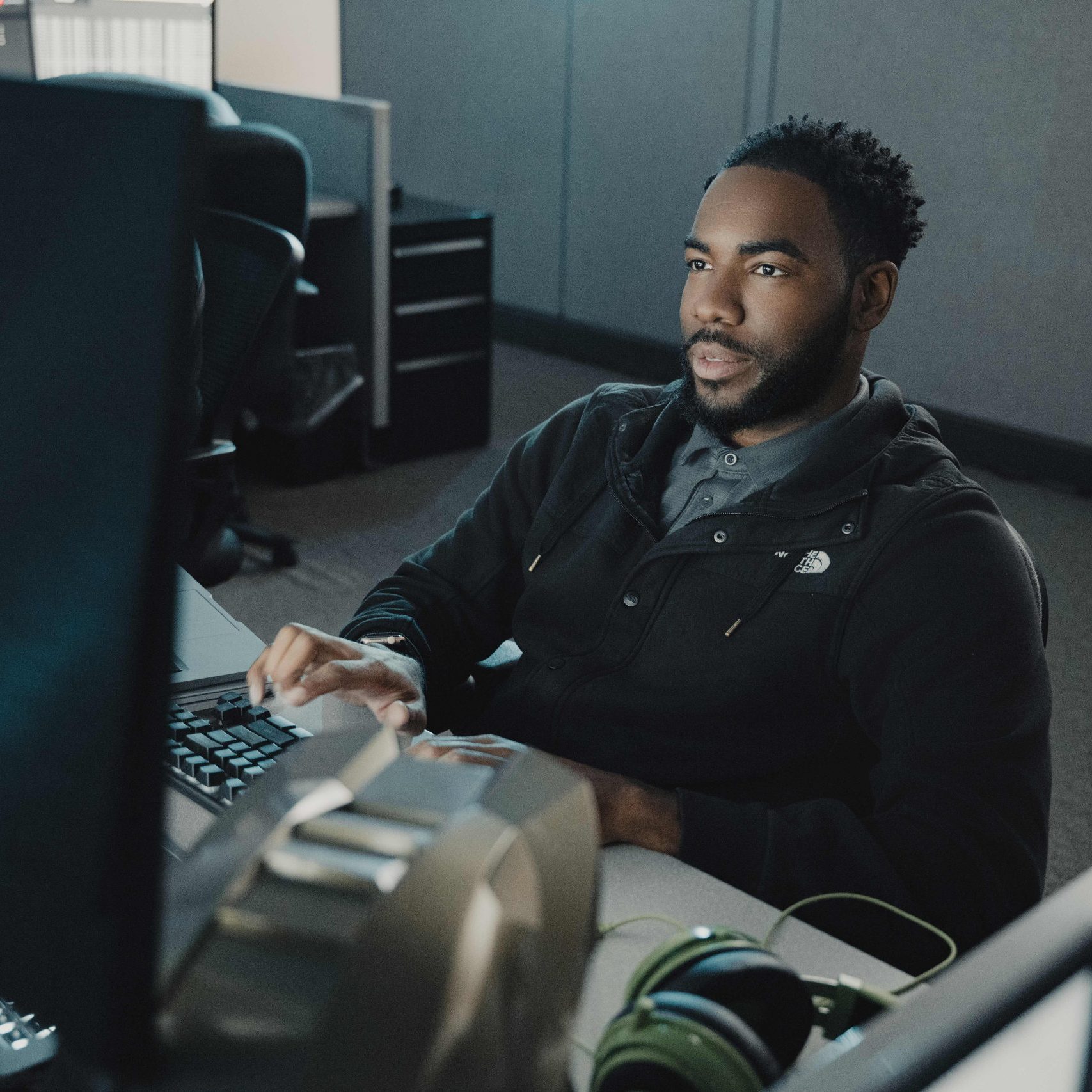 A member of the Clear Winds cybersecurity team at a computer.