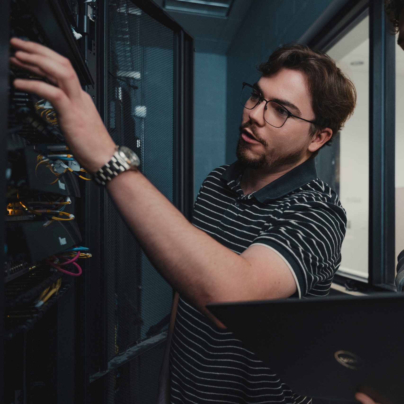 A member of the Clear Winds engineering team in a server room.