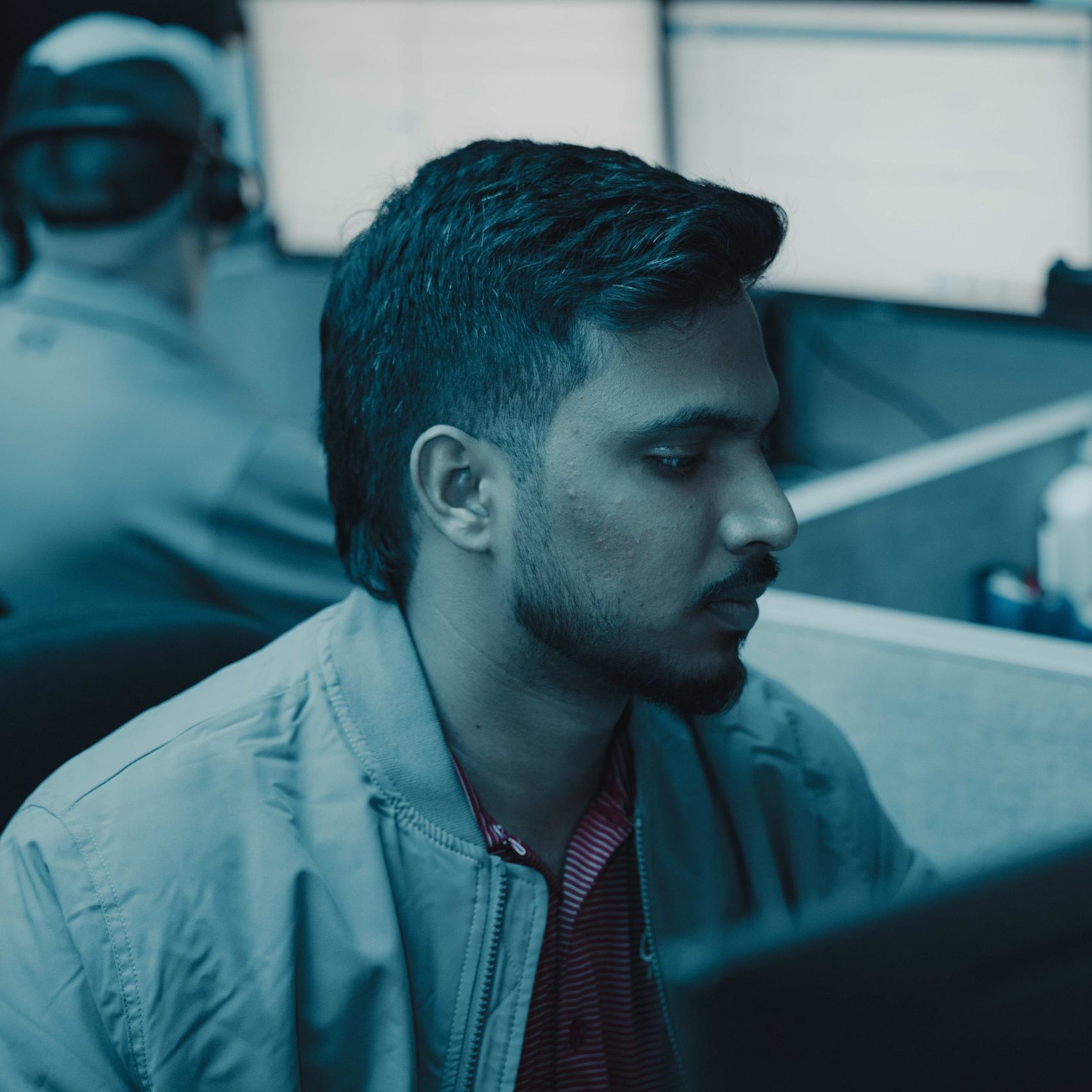 A member of the Clear Winds cloud and hosting team at a computer.