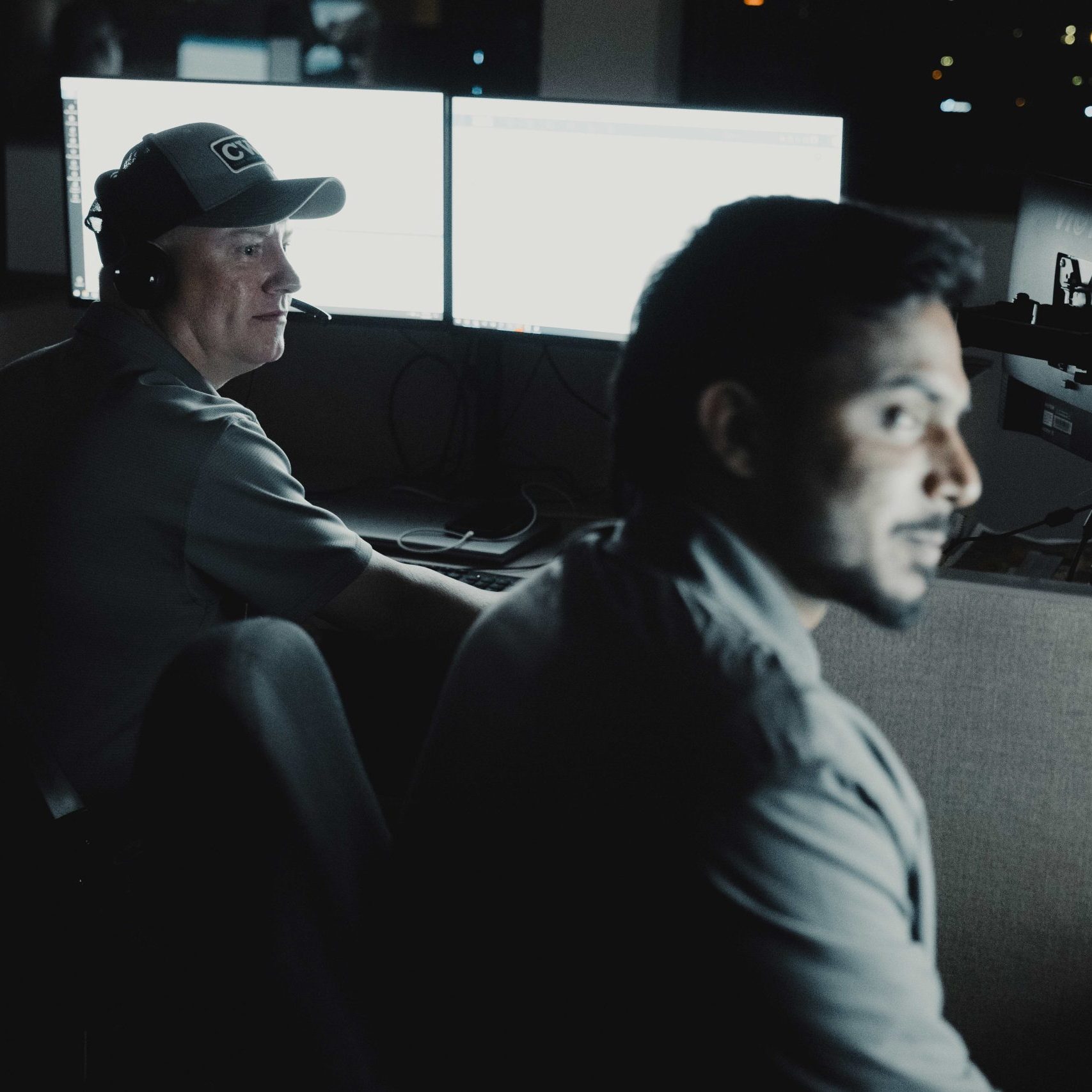 Members of the Clear Winds engineering team at a computer.