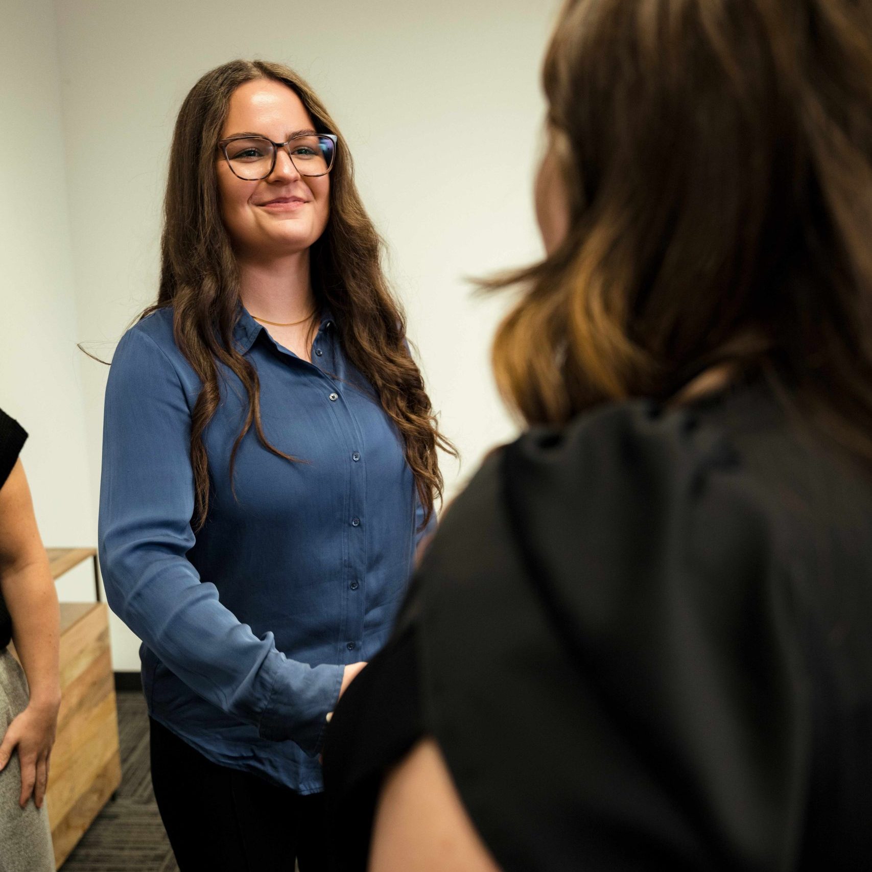 A member of the Clear Winds team shaking a client's hand.