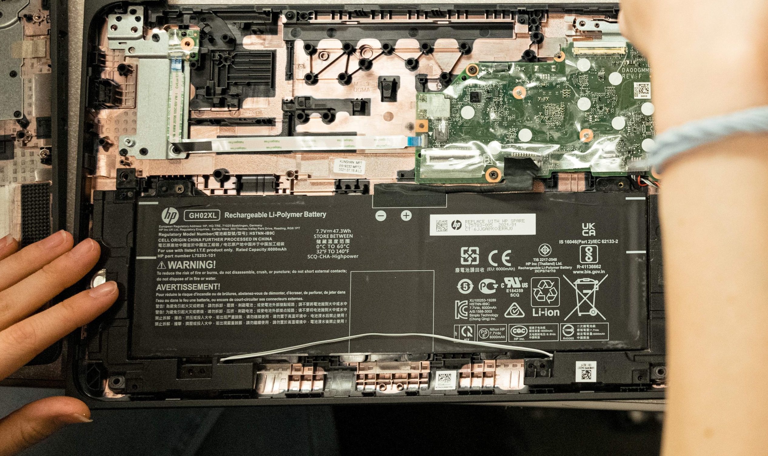 A member of a third-party device repair team fixing a broken Chromebook screen.