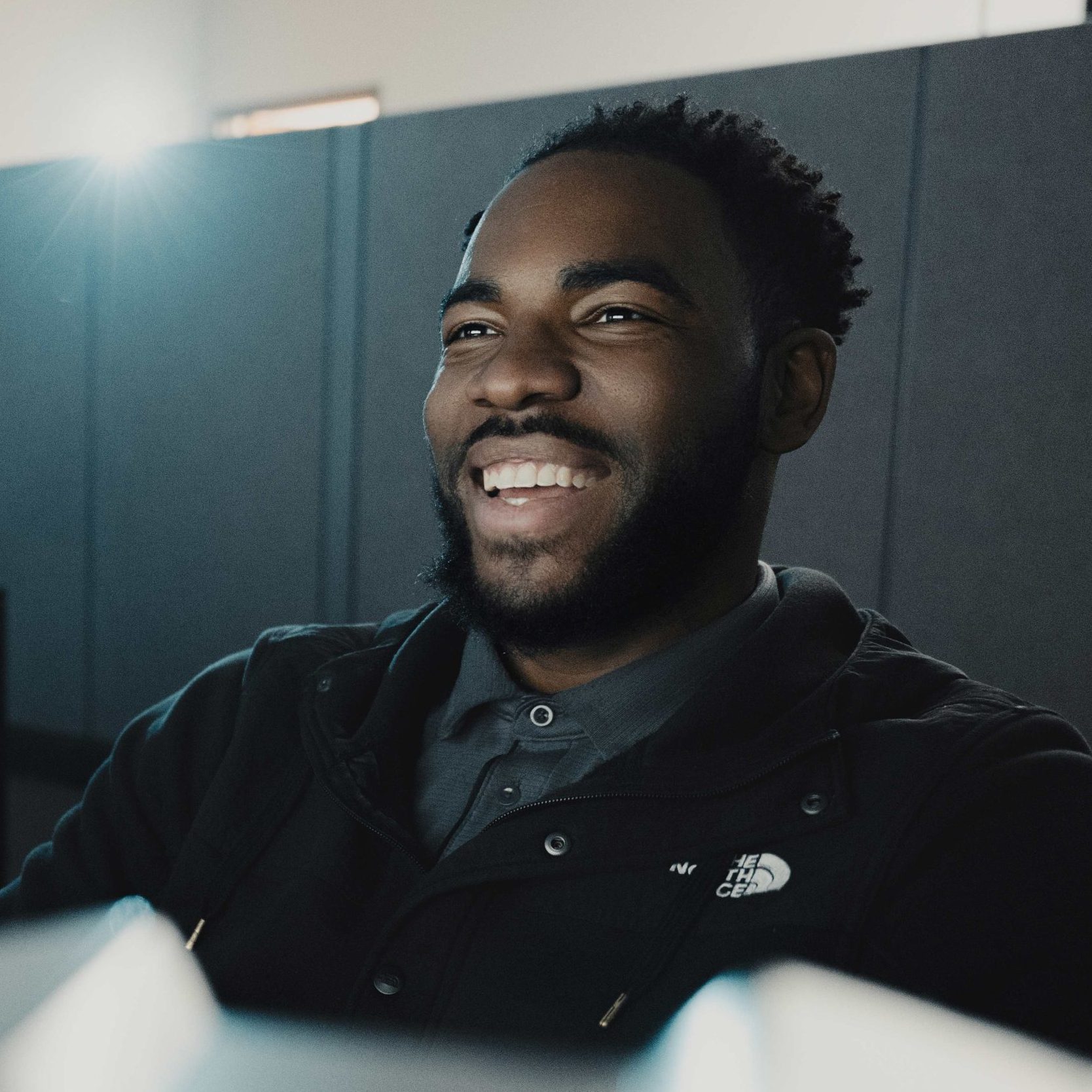 A Clear Winds employee at a computer, smiling