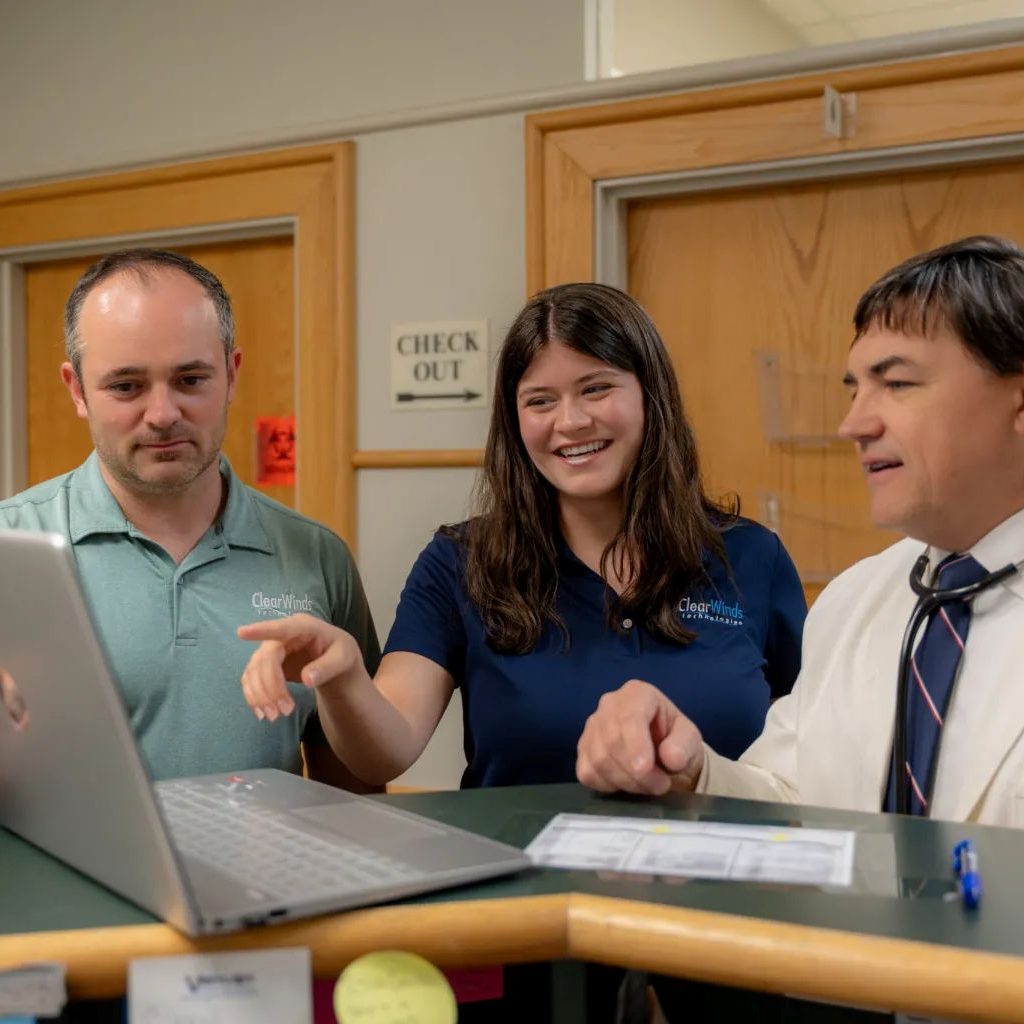 Members of the Clear Winds managed IT services in Georgetown team with a client.