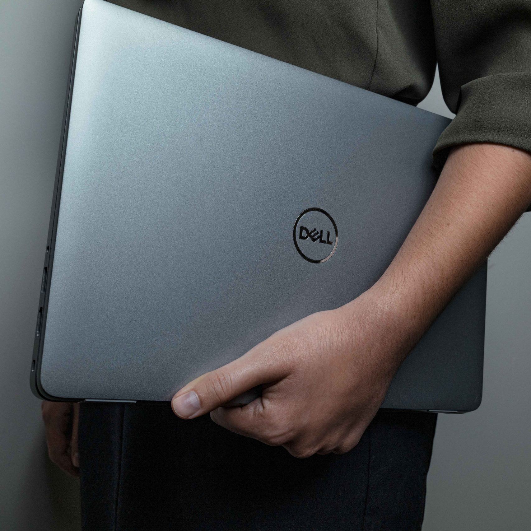 A Clear Winds employee holding a Dell laptop