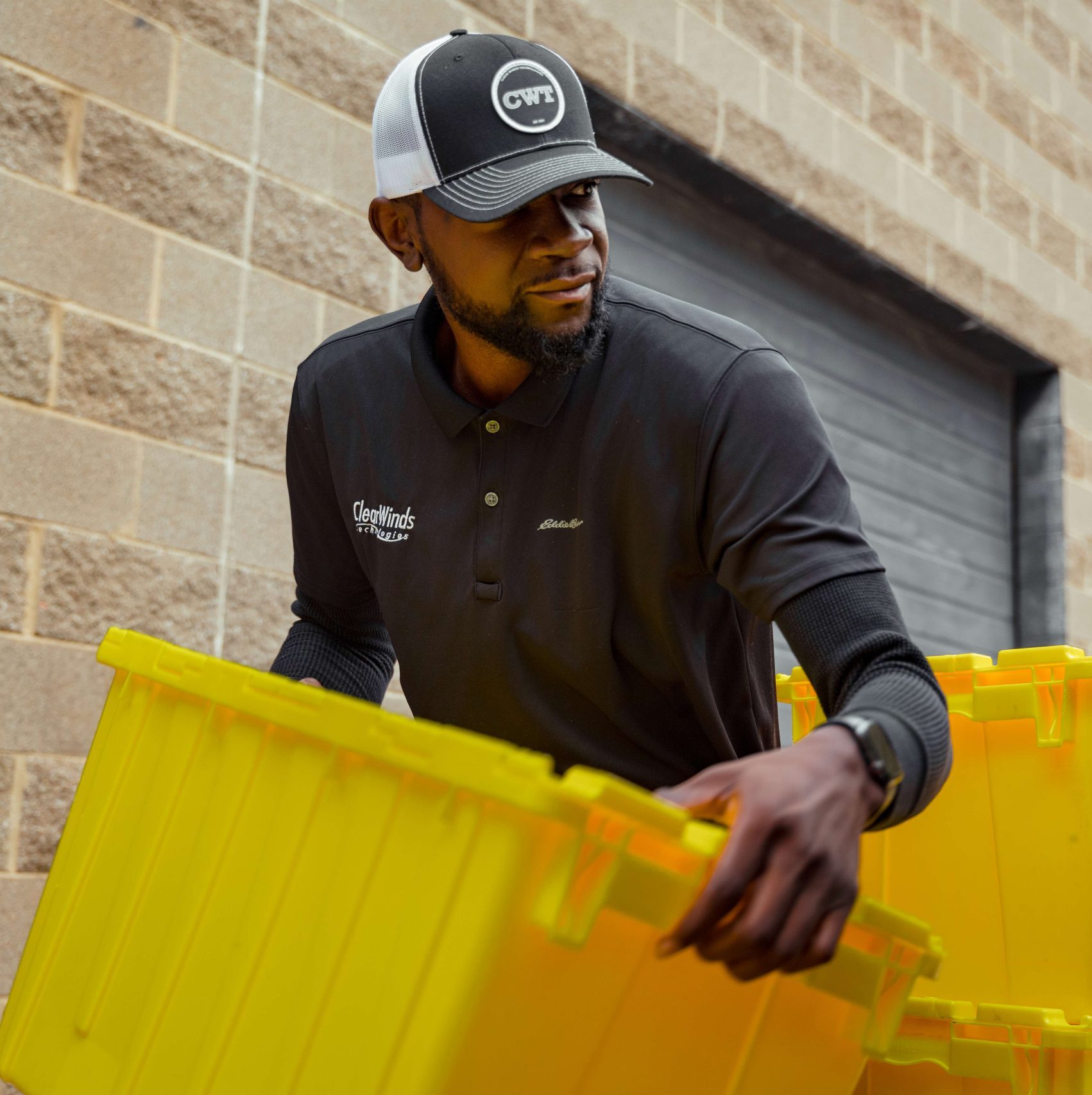 A member of the Clear Winds device repair team making a delivery.