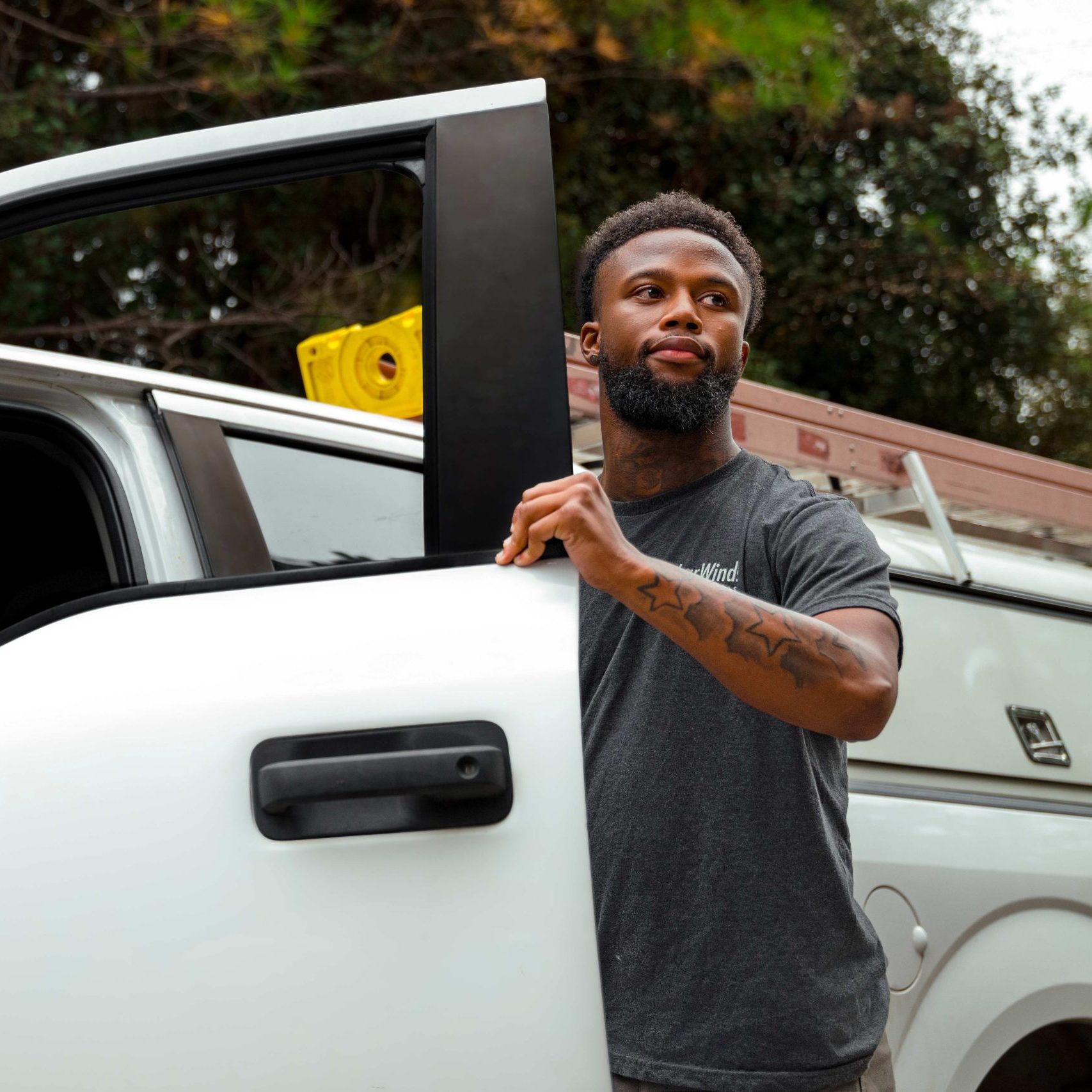 A member of the Clear Winds cabling team getting out of a car.