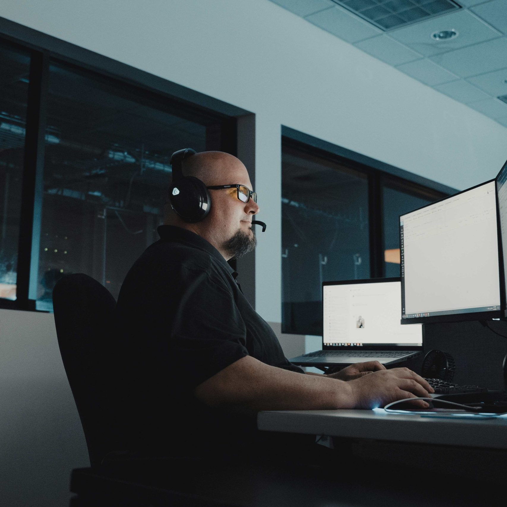 A Clear Winds help desk team member at a computer.