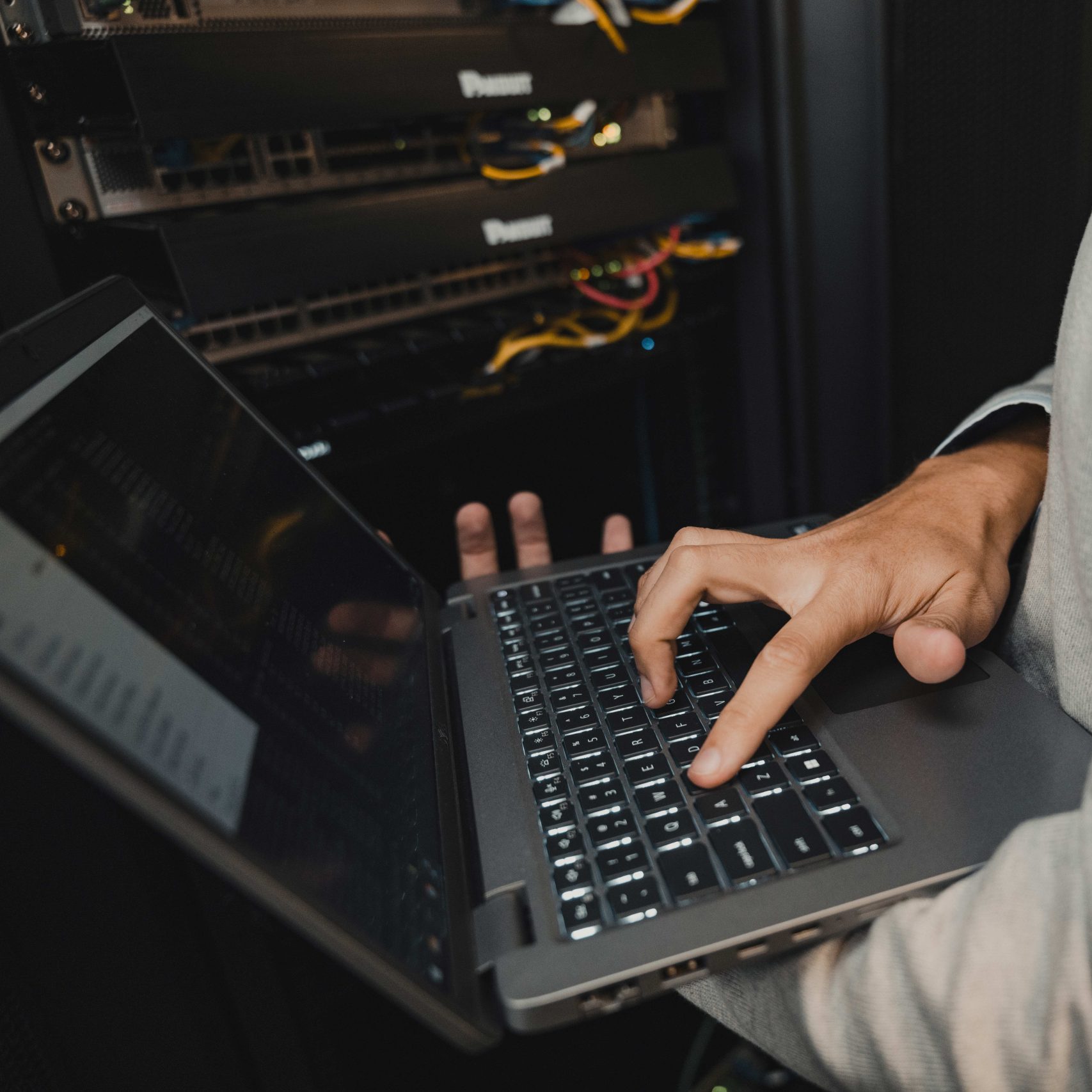 A member of the Clear Winds cybersecurity team on a computer.