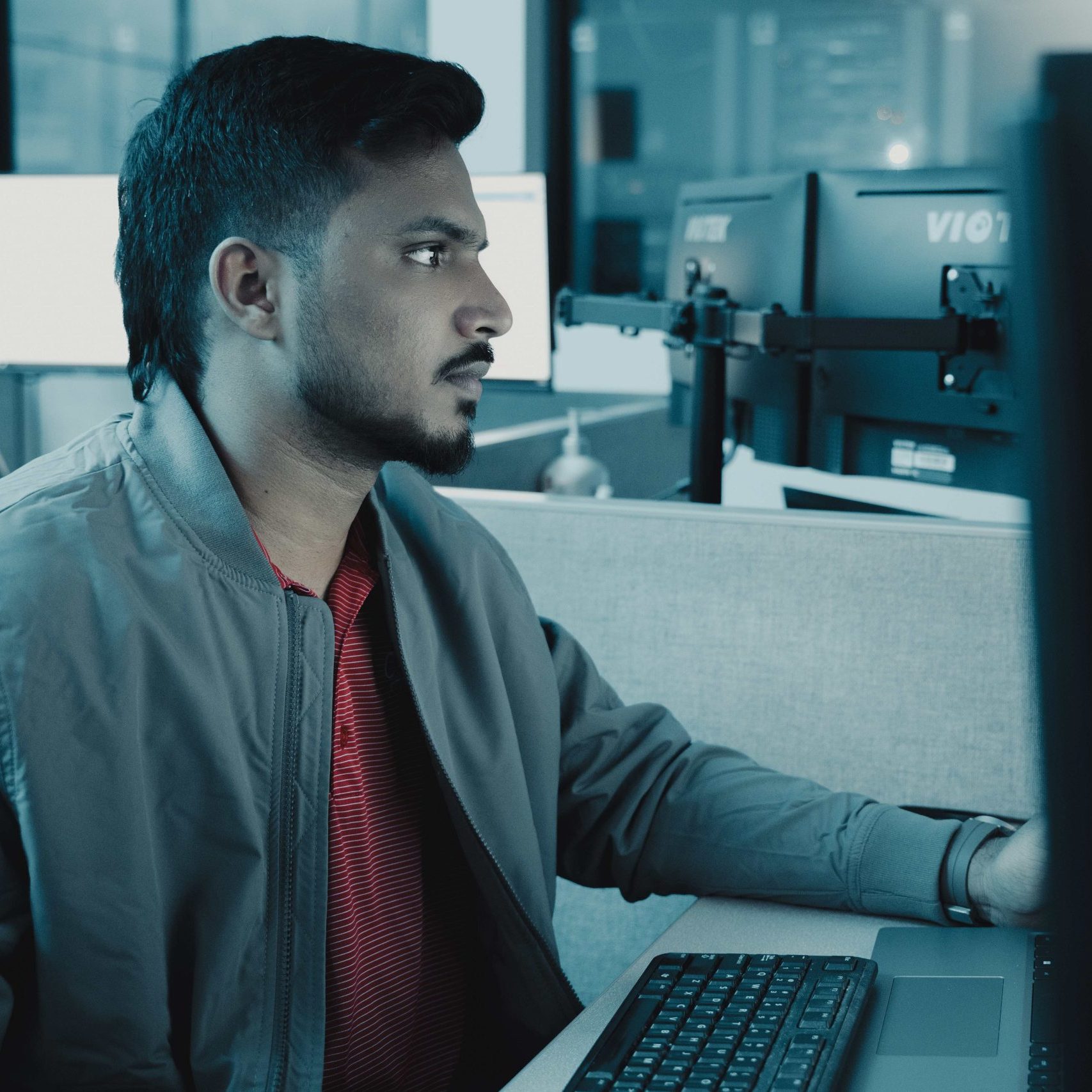 A Clear Winds Technologies IT expert at a computer.