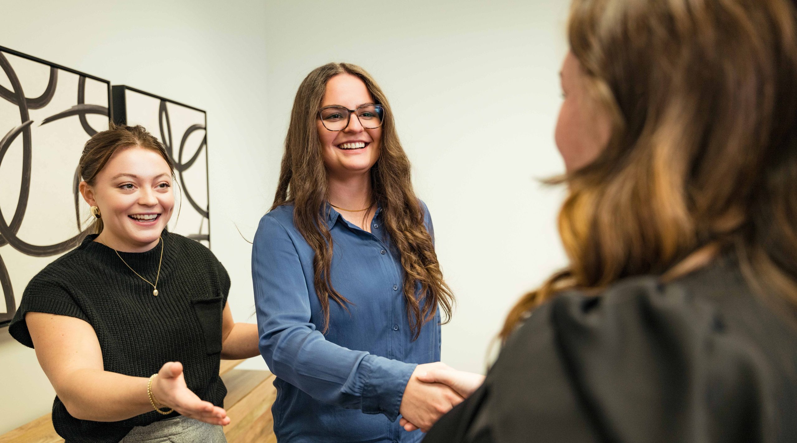 IT Support Austin: Two members of the Clear Winds team shaking hands with a client