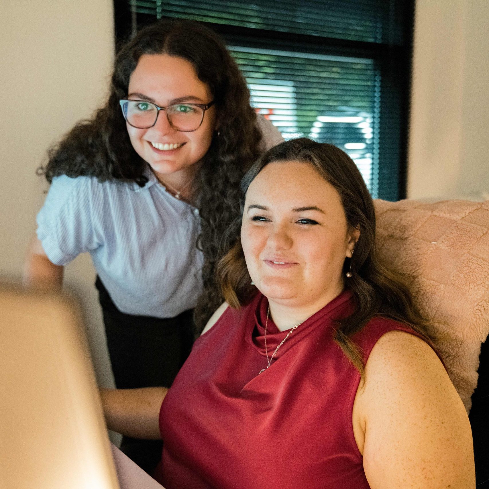 Members of the Clear Winds managed IT services in Carrollton team at a computer.