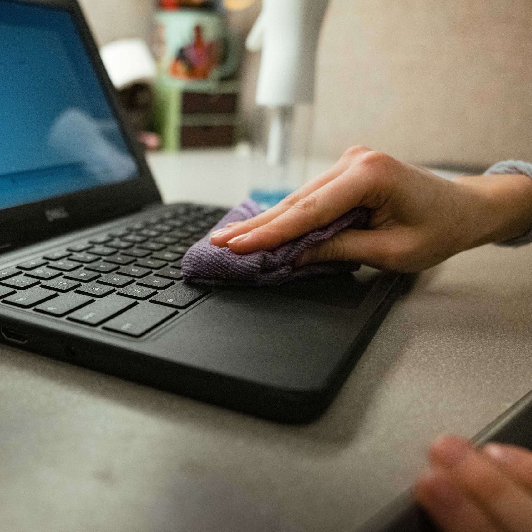 A Clear Winds device repair technician sanitizing a device.