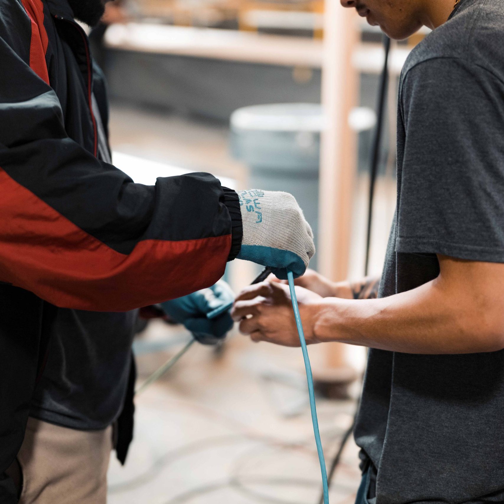 Two members of the Clear Winds cabling team holding cable.