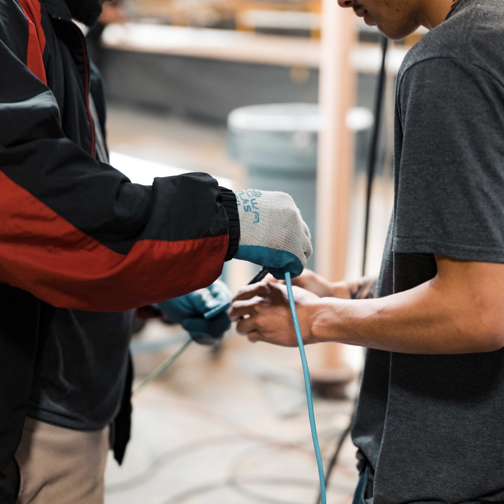 Two members of the Clear Winds cabling team with cable.