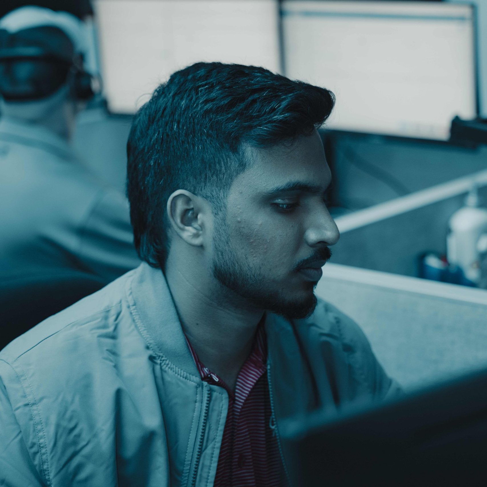 A Clear Winds cybersecurity professional at a computer.