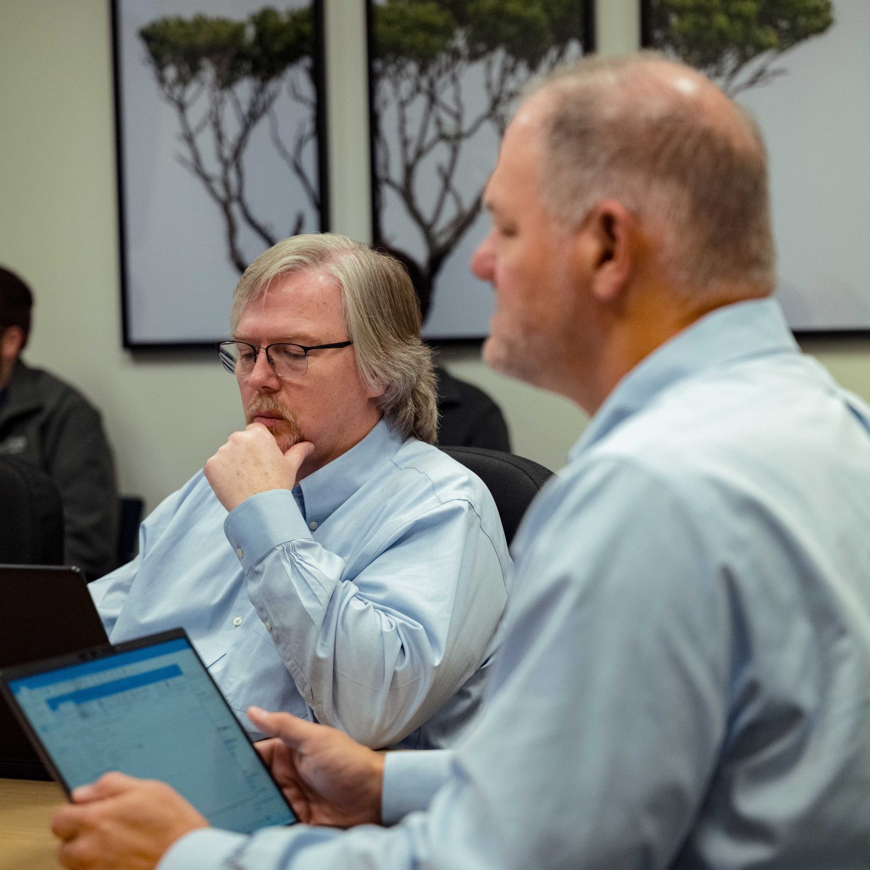 Members of the Clear Winds executive team in a meeting.