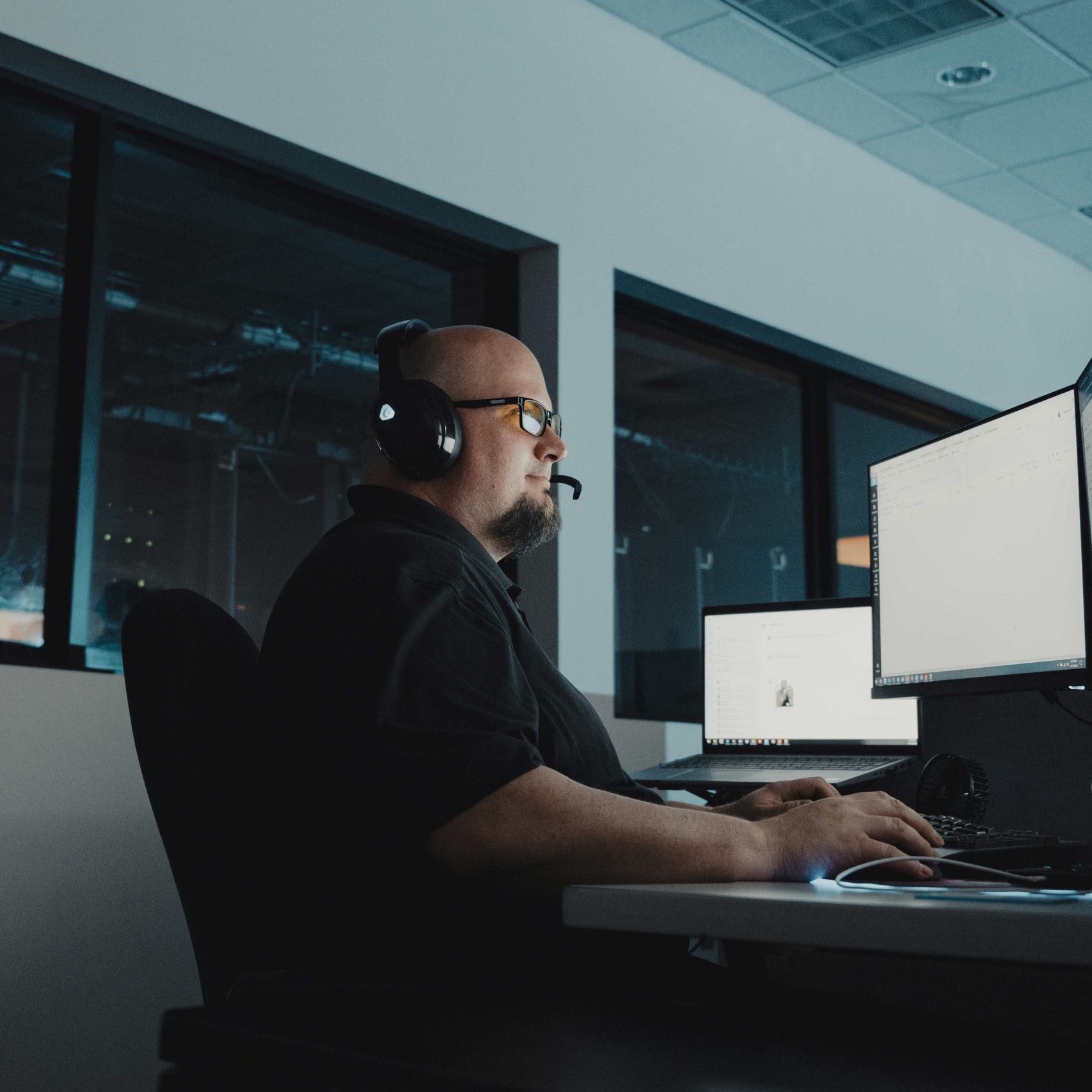 A Clear Winds cybersecurity professional at a computer.