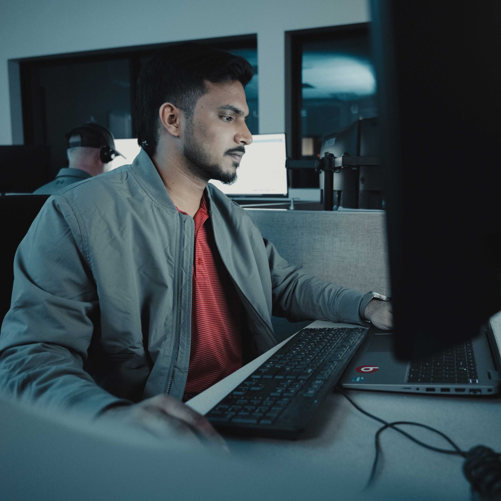 A Clear Winds cybersecurity specialist at a computer.