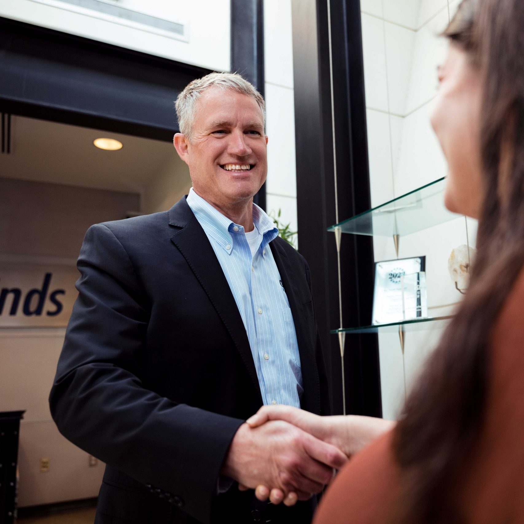 A Clear Winds executive team member shaking hands with a client.