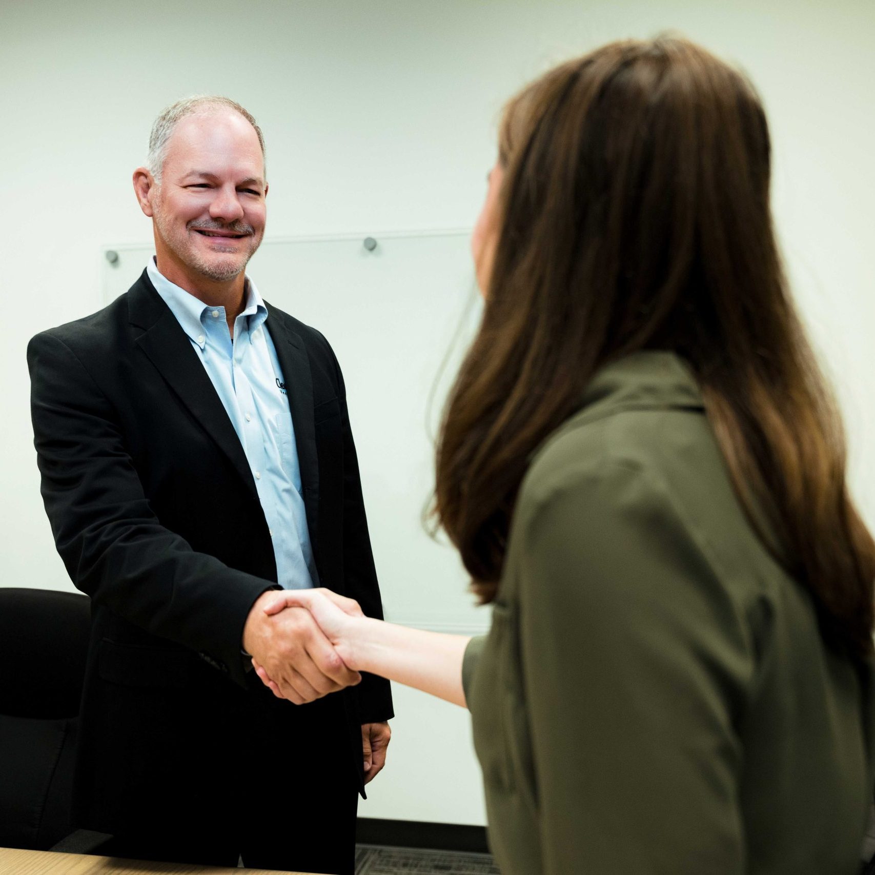 Clear Winds president and CEO, Stan Sargent shaking hands with a client.