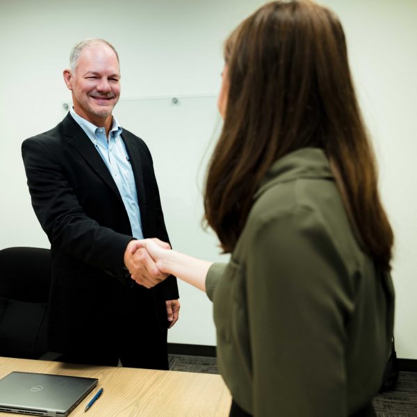 The President & CEO of Clear Winds shaking hands with Small and Medium Size business client.