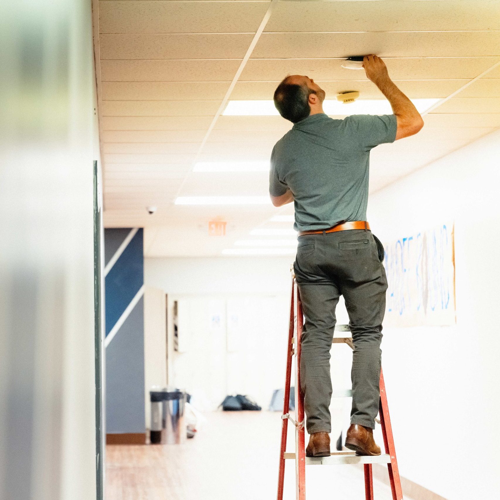 A Clear Winds team member installing an access point.