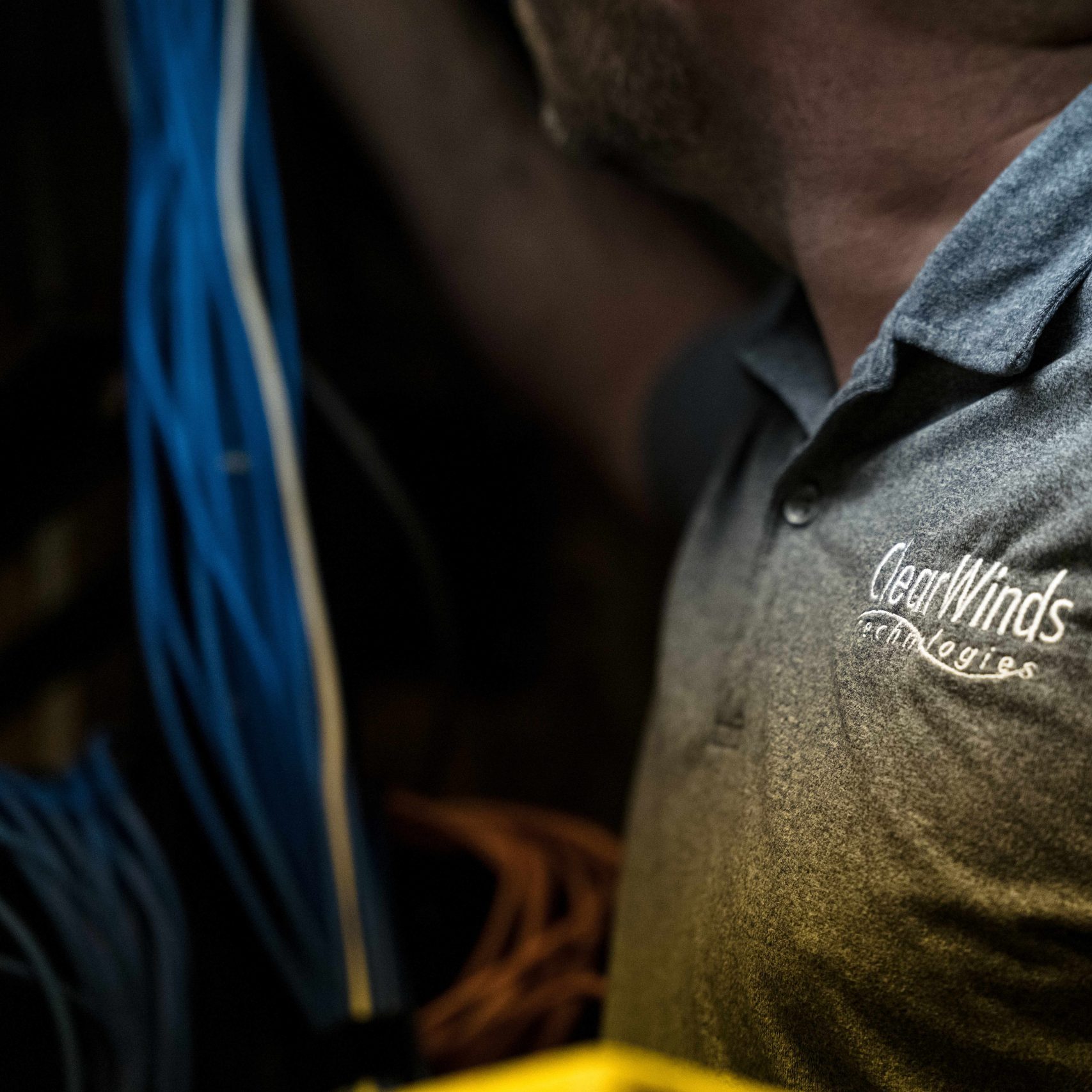 A Clear Winds team member installing equipment.