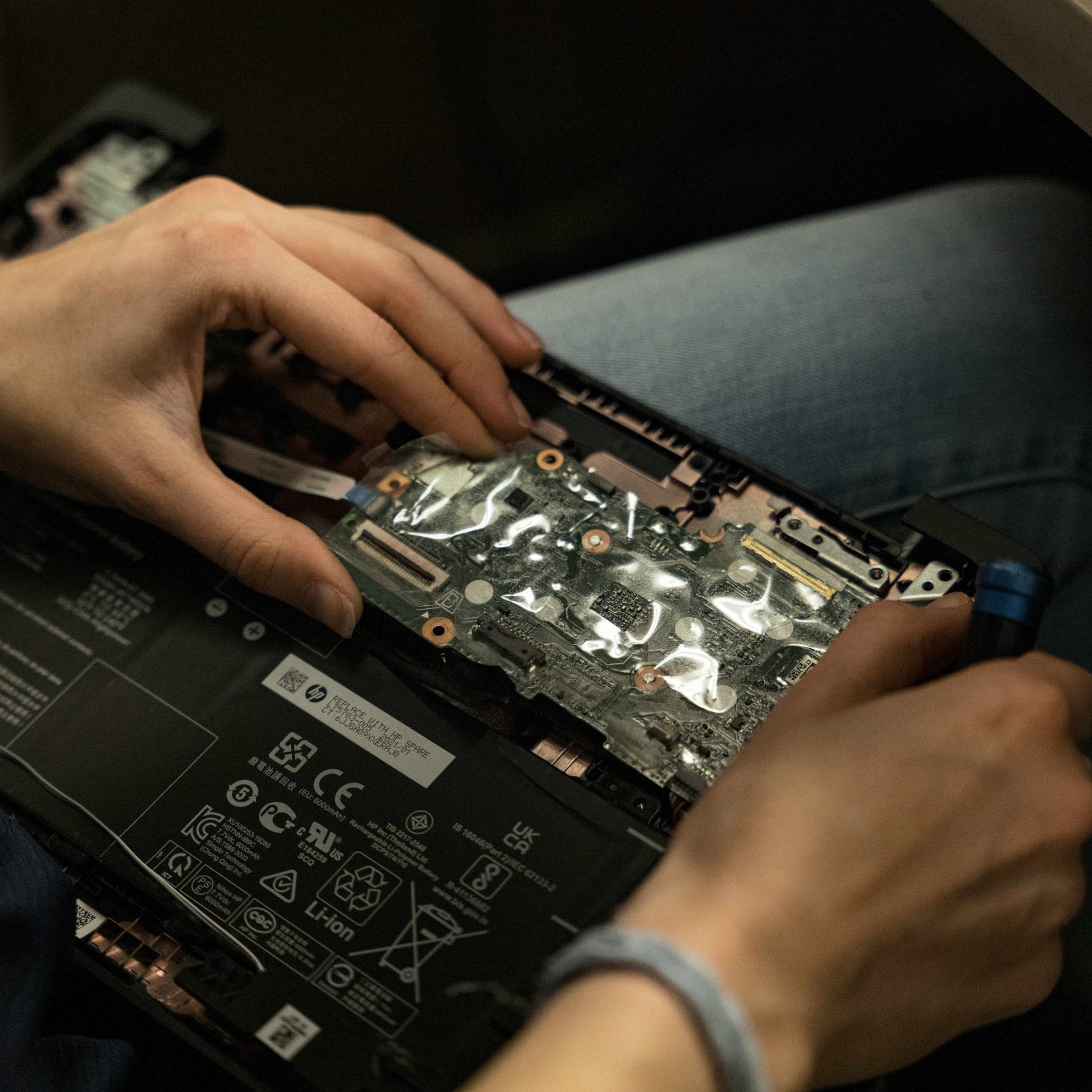 A Clear Winds team member repairing a motherboard.