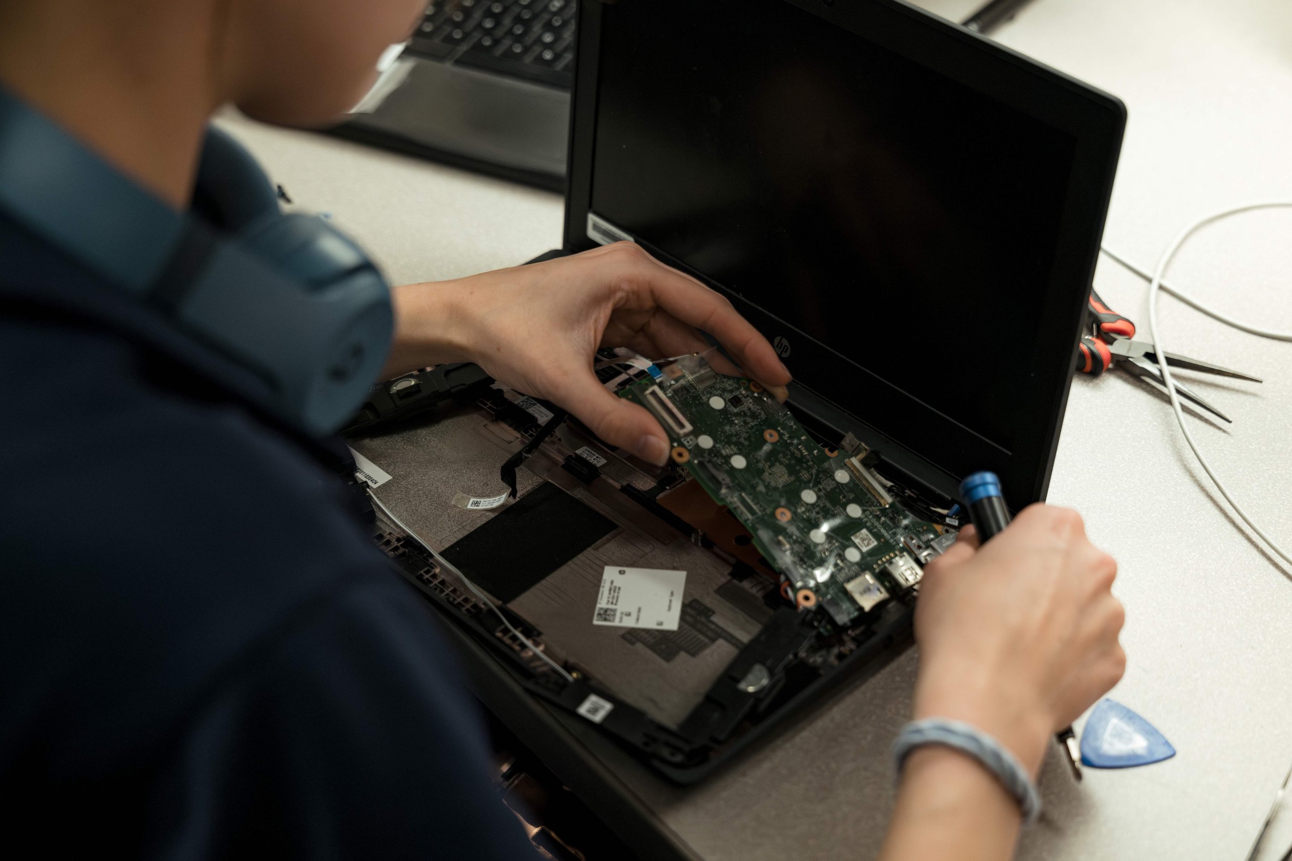 A tech working on a refurbished chromebook